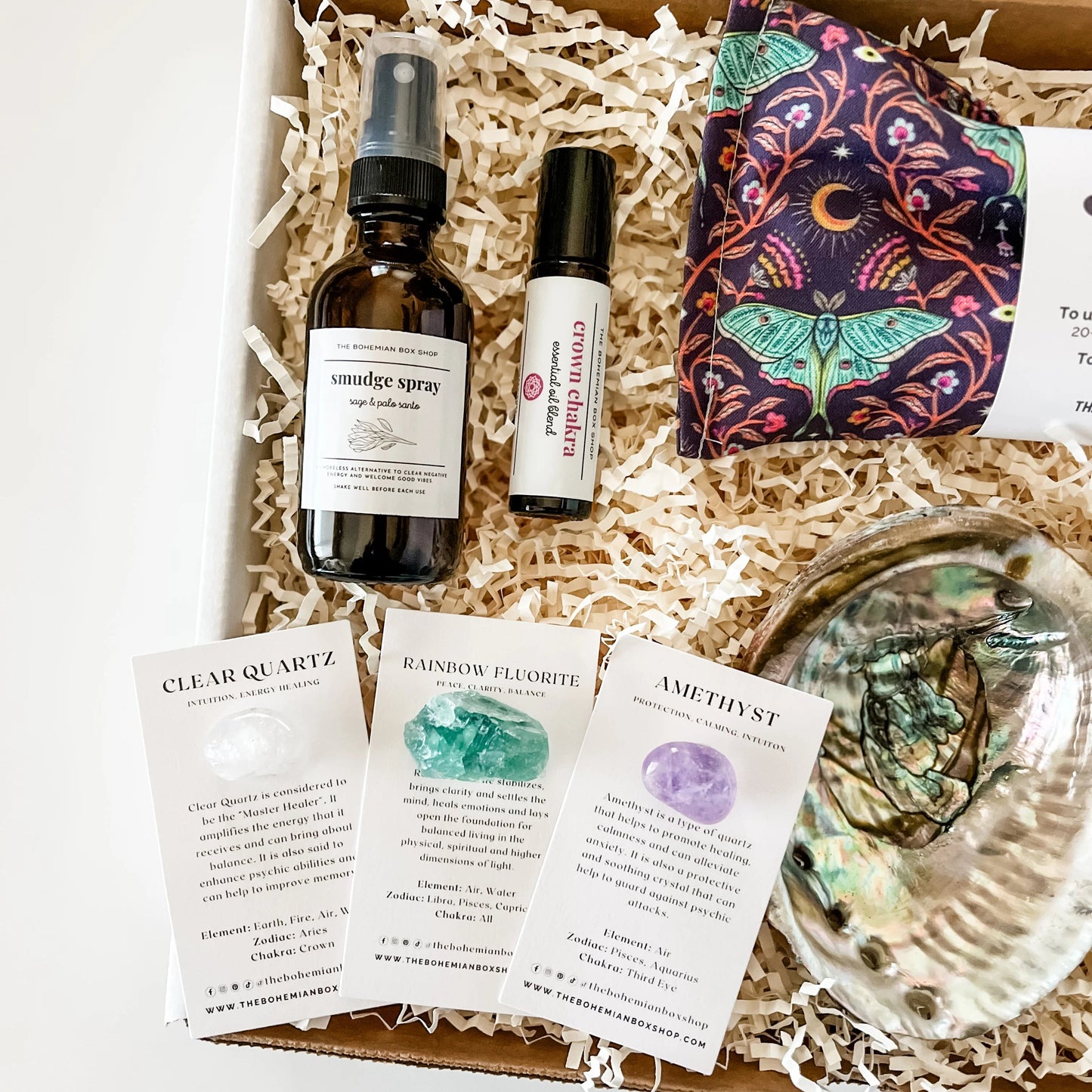 Crown Chakra Healing Gift Set. Includes smudge spray, crystals, crown chakra roller bottle, smudge kit, and Luna moth lavender eye pillow. 